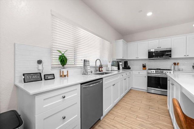 859 Windmill Ave, Clovis, CA 93619 - kitchen featuring appliances with stainless steel finishes, backsplash, white cabinets, light countertops, and light wood-type flooring