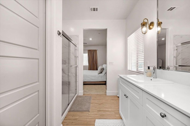 859 Windmill Ave, Clovis, CA 93619 - full bath featuring a marble finish shower, vanity, wood finished floors, and healthy amount of natural light