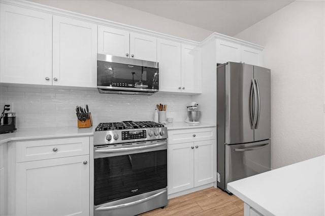 859 Windmill Ave, Clovis, CA 93619 - kitchen with appliances with stainless steel finishes, decorative backsplash, light countertops, and white cabinets
