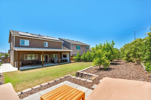 859 Windmill Ave, Clovis, CA 93619 - back of house with a patio, roof mounted solar panels, and stucco siding