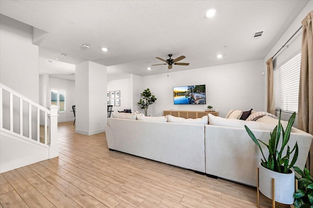 859 Windmill Ave, Clovis, CA 93619 - living room with stairs, recessed lighting, light wood finished floors, and a ceiling fan