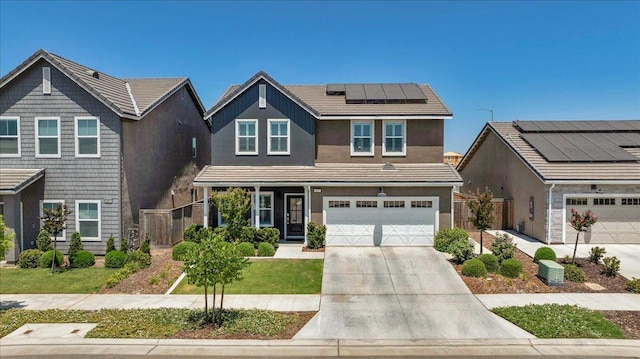 859 Windmill Ave, Clovis, CA 93619 - traditional-style home with concrete driveway, roof mounted solar panels, a garage, covered porch, and stucco siding