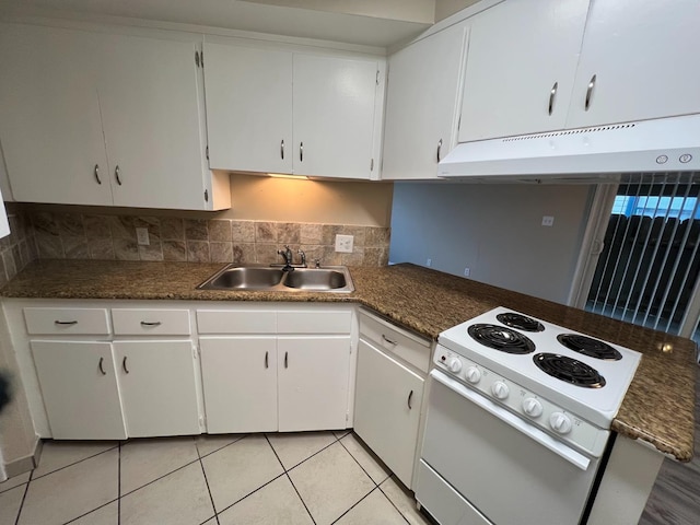 1205 F St, Reedley, CA 93654 - kitchen featuring electric range, under cabinet range hood, white cabinetry, light tile patterned flooring, and dark countertops