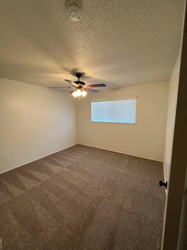 1205 F St, Reedley, CA 93654 - spare room with ceiling fan, carpet flooring, a textured ceiling, and a smoke detector