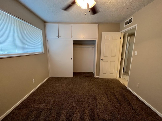 1205 F St, Reedley, CA 93654 - unfurnished bedroom featuring dark carpet, a textured ceiling, a closet, and a ceiling fan