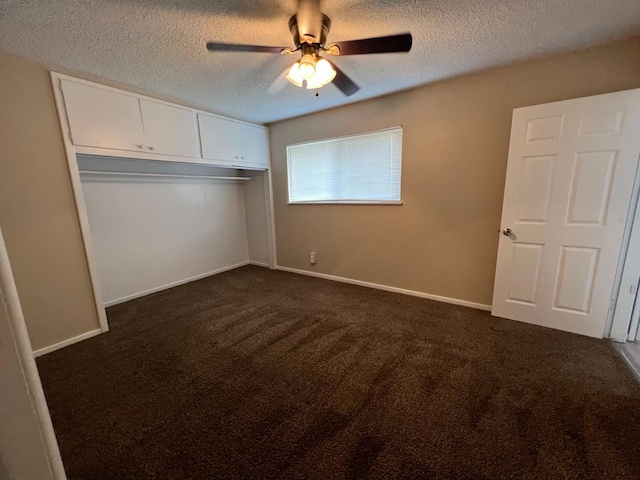 1205 F St, Reedley, CA 93654 - unfurnished bedroom featuring a textured ceiling, dark colored carpet, a closet, and ceiling fan
