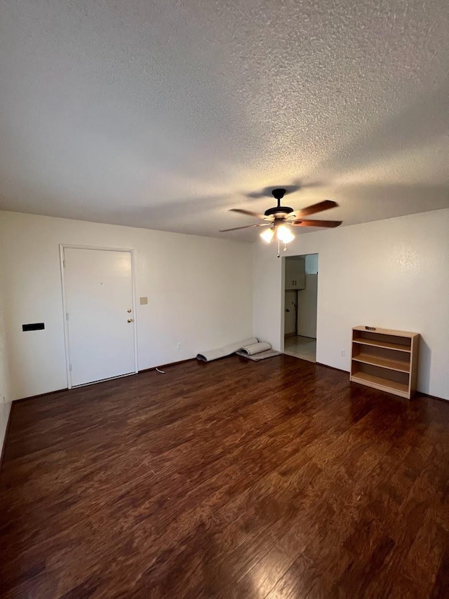 1205 F St, Reedley, CA 93654 - unfurnished living room with wood finished floors, a ceiling fan, and a textured ceiling