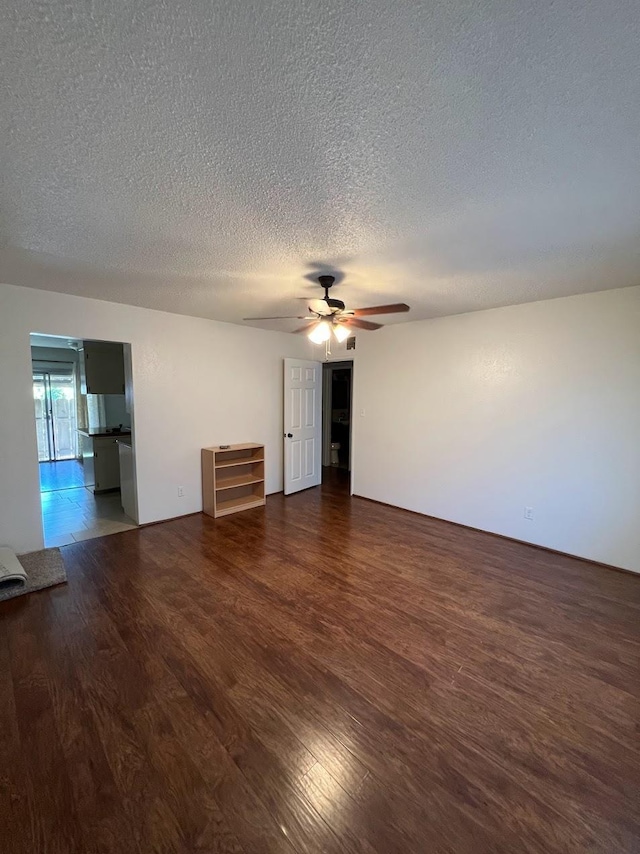 1205 F St, Reedley, CA 93654 - empty room with a textured ceiling, wood finished floors, and a ceiling fan