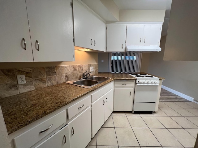 1205 F St, Reedley, CA 93654 - kitchen featuring electric stove, under cabinet range hood, tasteful backsplash, and white cabinets