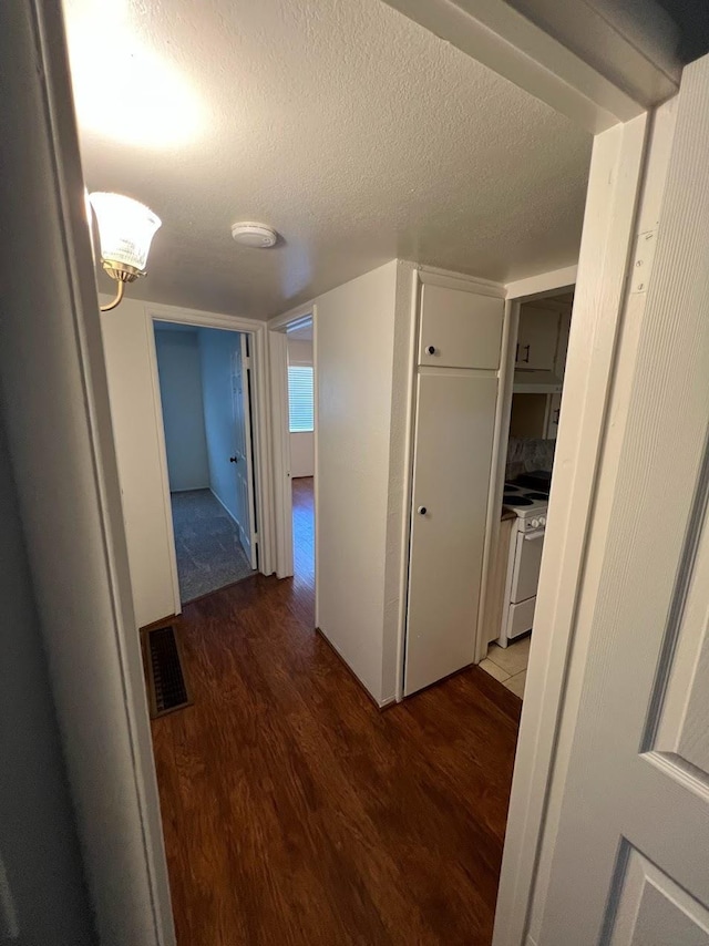 1205 F St, Reedley, CA 93654 - hall featuring wood finished floors and a textured ceiling