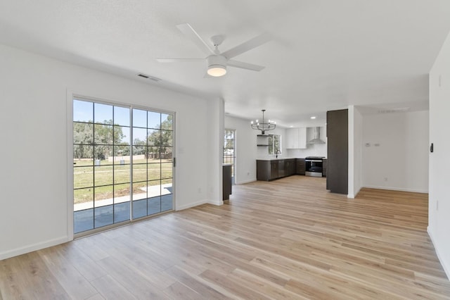 19730 Brightwood Rd, Madera, CA 93638 - unfurnished living room featuring a chandelier, ceiling fan, and light wood finished floors