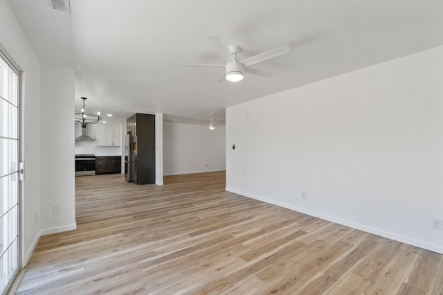 19730 Brightwood Rd, Madera, CA 93638 - unfurnished living room featuring ceiling fan, light wood-style flooring, and a chandelier