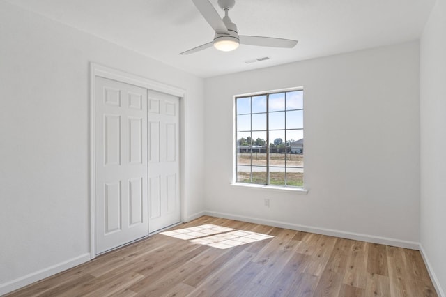 19730 Brightwood Rd, Madera, CA 93638 - unfurnished bedroom featuring a closet, light wood-style floors, and ceiling fan