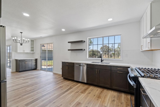19730 Brightwood Rd, Madera, CA 93638 - kitchen featuring dishwasher, open shelves, ventilation hood, range with gas stovetop, and light wood-type flooring