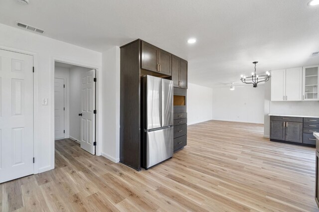 19730 Brightwood Rd, Madera, CA 93638 - kitchen featuring freestanding refrigerator, dark brown cabinets, a chandelier, light wood-style flooring, and hanging light fixtures