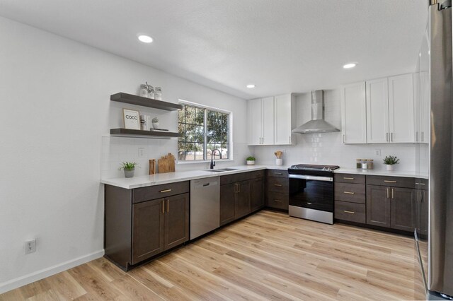 19730 Brightwood Rd, Madera, CA 93638 - kitchen with stainless steel appliances, wall chimney range hood, light countertops, white cabinetry, and recessed lighting