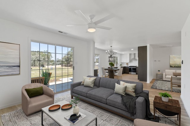 19730 Brightwood Rd, Madera, CA 93638 - living area with a chandelier, light wood finished floors, and a ceiling fan
