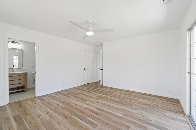 19730 Brightwood Rd, Madera, CA 93638 - unfurnished bedroom featuring light wood finished floors, ensuite bath, and a ceiling fan