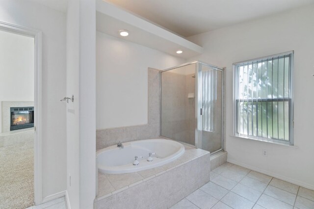 122 E Loop, Madera, CA 93637 - full bathroom with a garden tub, a stall shower, a fireplace, tile patterned flooring, and recessed lighting