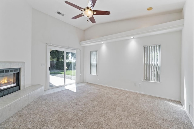 122 E Loop, Madera, CA 93637 - unfurnished living room featuring carpet floors, ceiling fan, a tile fireplace, and lofted ceiling