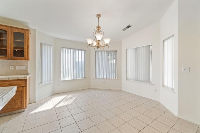 122 E Loop, Madera, CA 93637 - unfurnished dining area featuring a chandelier and light tile patterned flooring
