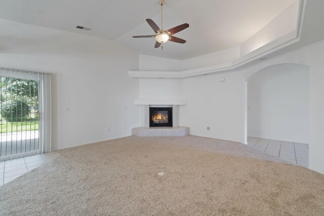 122 E Loop, Madera, CA 93637 - unfurnished living room featuring carpet, tile patterned floors, ceiling fan, a glass covered fireplace, and lofted ceiling