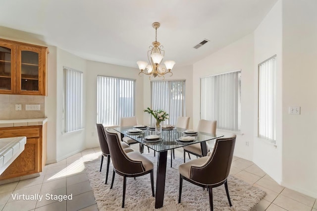122 E Loop, Madera, CA 93637 - dining space featuring a chandelier, plenty of natural light, and light tile patterned flooring