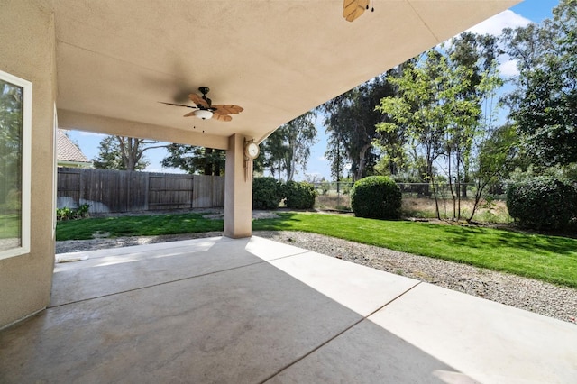 122 E Loop, Madera, CA 93637 - fenced backyard with a ceiling fan and a patio