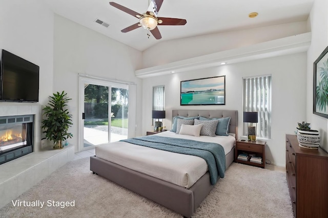 122 E Loop, Madera, CA 93637 - bedroom featuring access to exterior, carpet floors, vaulted ceiling, a tile fireplace, and ceiling fan