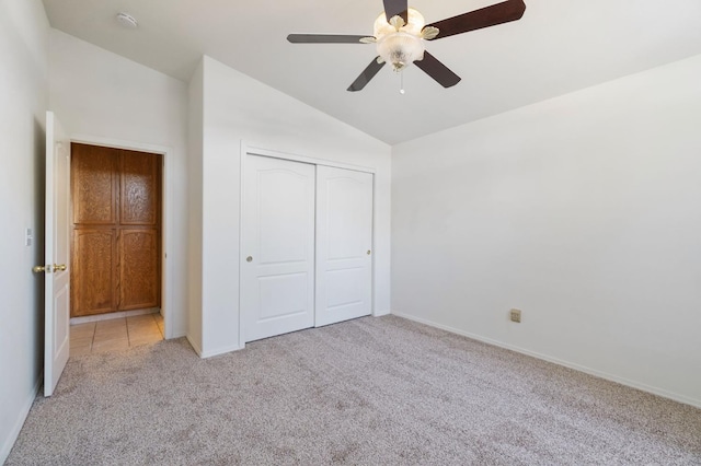 122 E Loop, Madera, CA 93637 - unfurnished bedroom featuring light colored carpet, lofted ceiling, a closet, and a ceiling fan