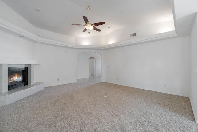 122 E Loop, Madera, CA 93637 - unfurnished living room with arched walkways, ceiling fan, carpet, a tile fireplace, and lofted ceiling