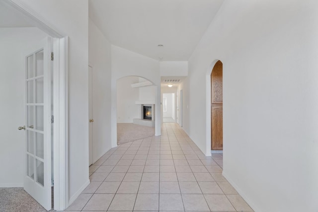122 E Loop, Madera, CA 93637 - corridor with arched walkways and light tile patterned flooring