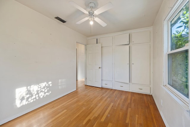 513 W Fountain Way, Fresno, CA 93705 - unfurnished bedroom featuring light wood finished floors, a closet, and a ceiling fan