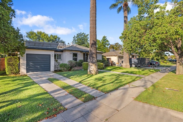 513 W Fountain Way, Fresno, CA 93705 - view of front of house featuring driveway, stucco siding, a front yard, and a garage