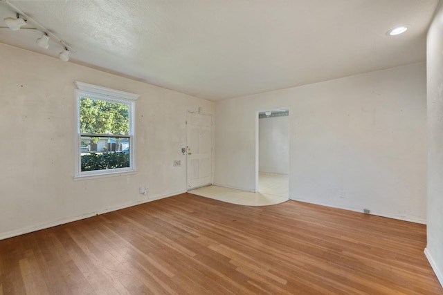 513 W Fountain Way, Fresno, CA 93705 - spare room with light wood-style floors and track lighting
