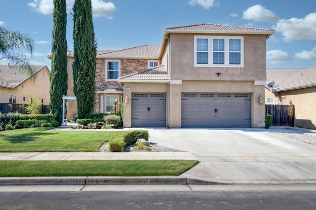 3016 San Gabriel Ave, Clovis, CA 93619 - view of front of property with a tile roof, stucco siding, concrete driveway, an attached garage, and stone siding