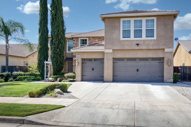3016 San Gabriel Ave, Clovis, CA 93619 - view of front of property featuring a tiled roof, driveway, stucco siding, and a garage