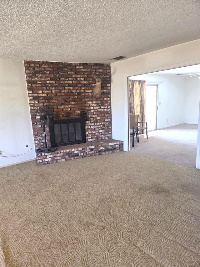 5525 S Fig Ave, Fresno, CA 93706 - unfurnished living room featuring carpet flooring, a brick fireplace, and a textured ceiling