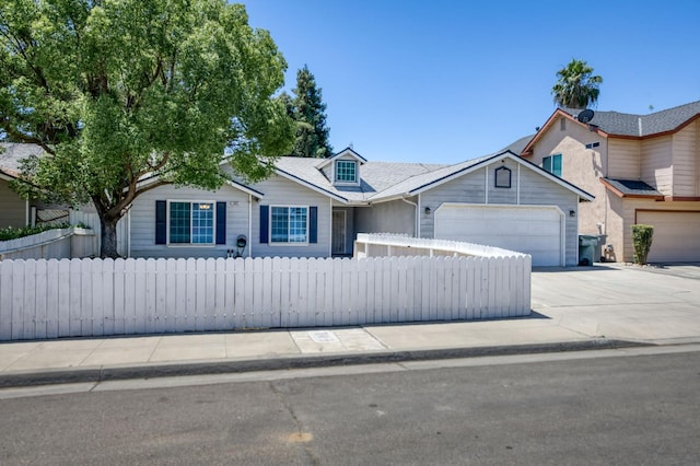 4665 W Yale Ave, Fresno, CA 93722 - view of front of house featuring a garage, concrete driveway, and a fenced front yard