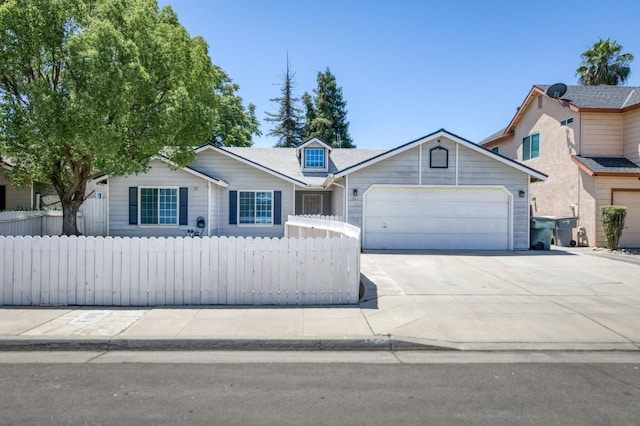 4665 W Yale Ave, Fresno, CA 93722 - view of front of house featuring an attached garage, concrete driveway, and a fenced front yard