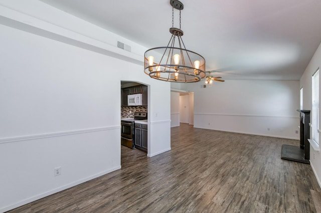 4665 W Yale Ave, Fresno, CA 93722 - unfurnished living room featuring a chandelier, dark wood-style floors, arched walkways, and a ceiling fan