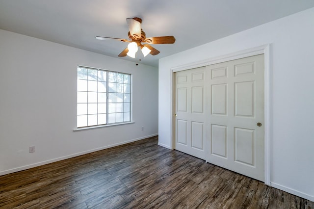 4665 W Yale Ave, Fresno, CA 93722 - unfurnished bedroom with dark wood-style flooring, a closet, and a ceiling fan