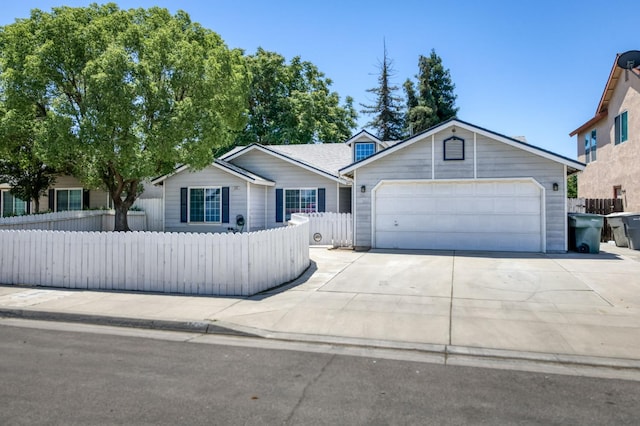4665 W Yale Ave, Fresno, CA 93722 - ranch-style house with driveway and a garage