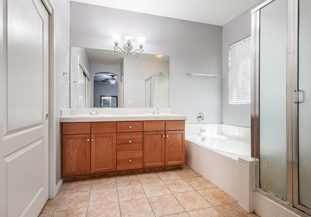 1734 Glen Oban Ln, Clovis, CA 93619 - full bathroom with a chandelier, double vanity, a bath, a shower stall, and tile patterned floors