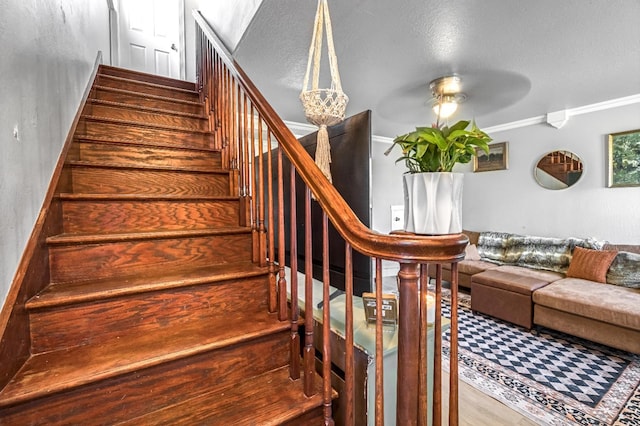 5098 E Ashlan Ave Unit 116, Fresno, CA 93727 - stairway featuring a ceiling fan, ornamental molding, and wood finished floors