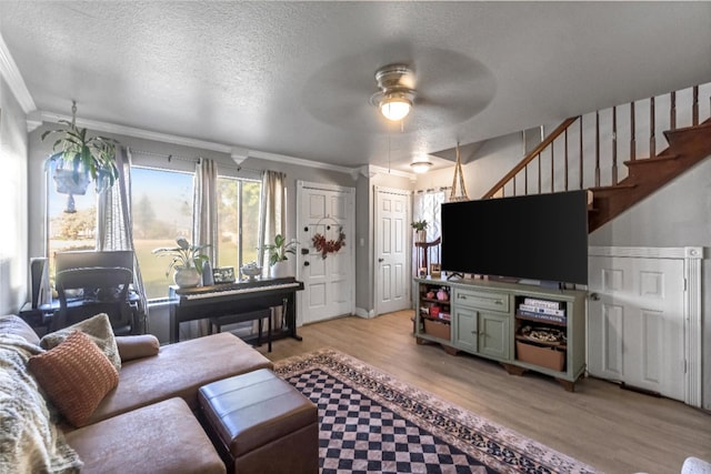 5098 E Ashlan Ave Unit 116, Fresno, CA 93727 - living area with crown molding, ceiling fan, light wood-style flooring, stairs, and a textured ceiling