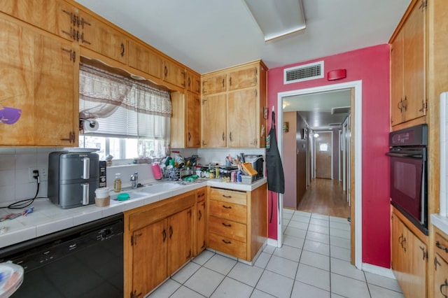 786 E Barstow Ave, Fresno, CA 93710 - kitchen featuring black appliances, light tile patterned floors, decorative backsplash, and tile countertops