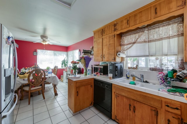 786 E Barstow Ave, Fresno, CA 93710 - kitchen with stainless steel appliances, plenty of natural light, brown cabinetry, and light tile patterned floors