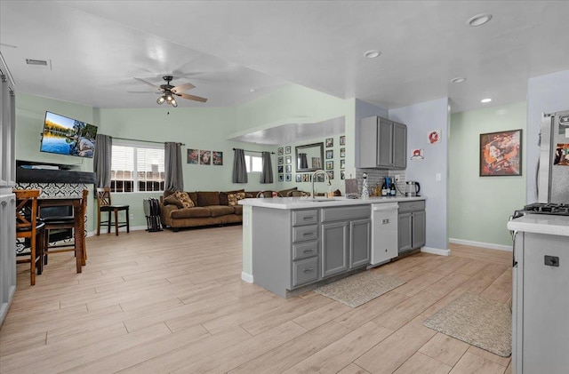 3673 N Denali Ave, Fresno, CA 93727 - kitchen featuring gray cabinetry, dishwasher, ceiling fan, light wood-style flooring, and recessed lighting