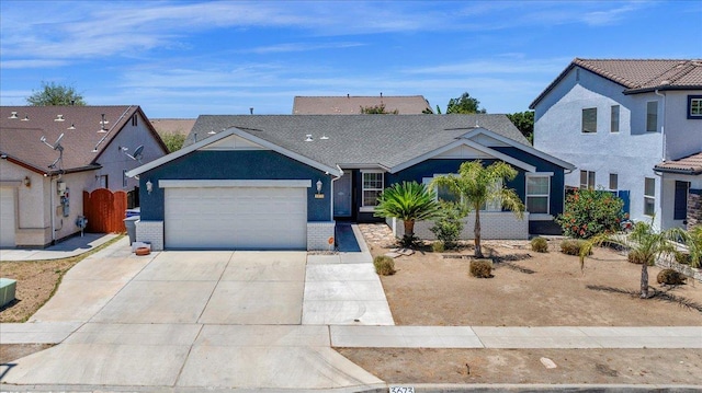 3673 N Denali Ave, Fresno, CA 93727 - view of front of home featuring a garage, driveway, and a residential view